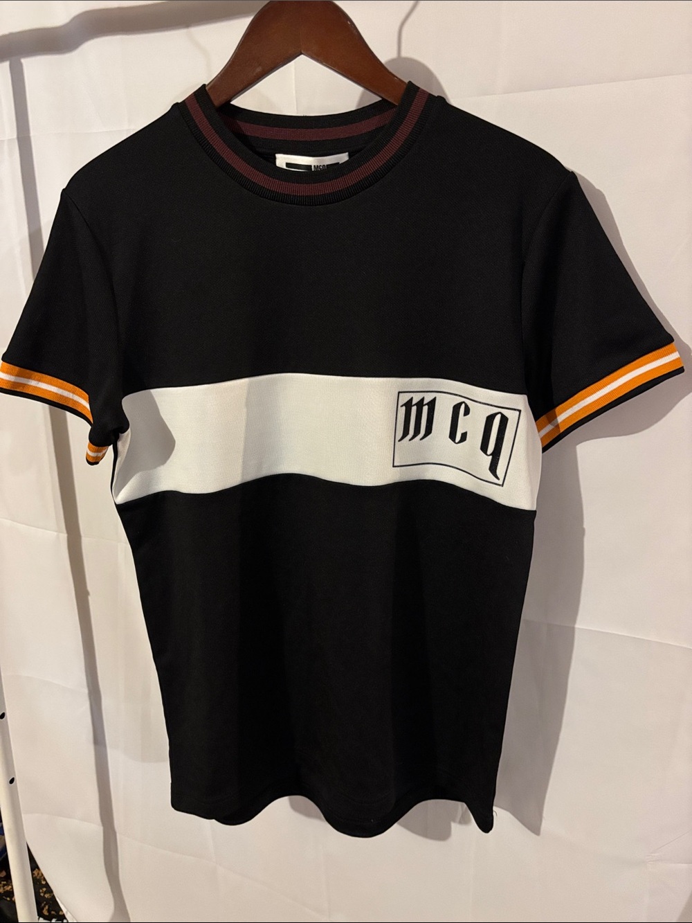 McQ by Alexander McQueen Black Tee with White Chest Panel and Orange Trim